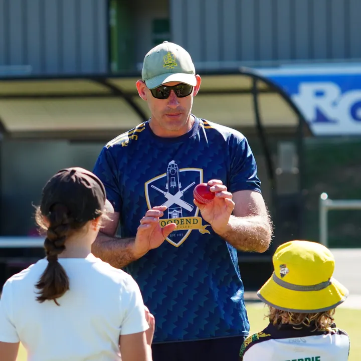 A Woodend coach showing junior players how to grip the ball