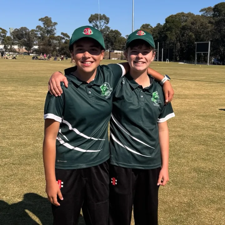 Two Woodend girls cricketers in club shirts
