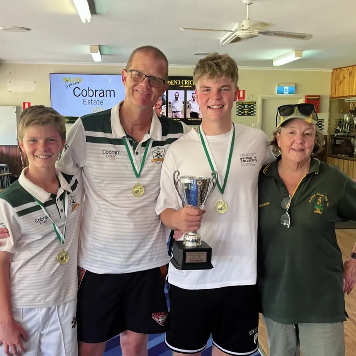 Woodend players and family with a trophy in the clubrooms