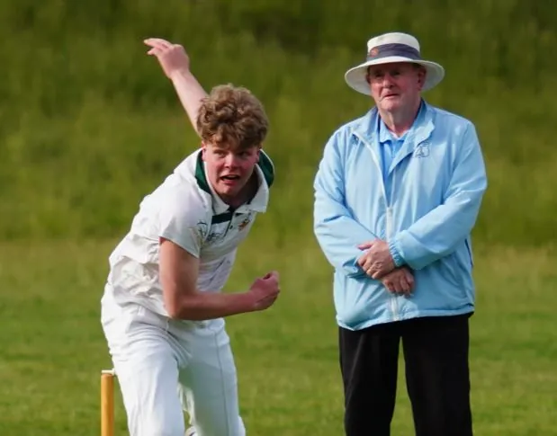 An Under 17 bowler in his delivery stride
